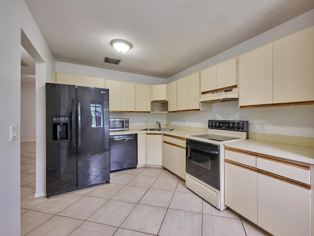 151 Meadows Dr, Boynton Beach, FL 33436 - kitchen featuring black appliances, cream cabinetry, under cabinet range hood, a sink, and light countertops