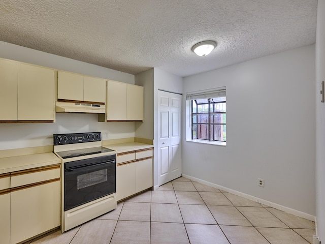 151 Meadows Dr, Boynton Beach, FL 33436 - kitchen with cream cabinets, electric stove, under cabinet range hood, light countertops, and a textured ceiling