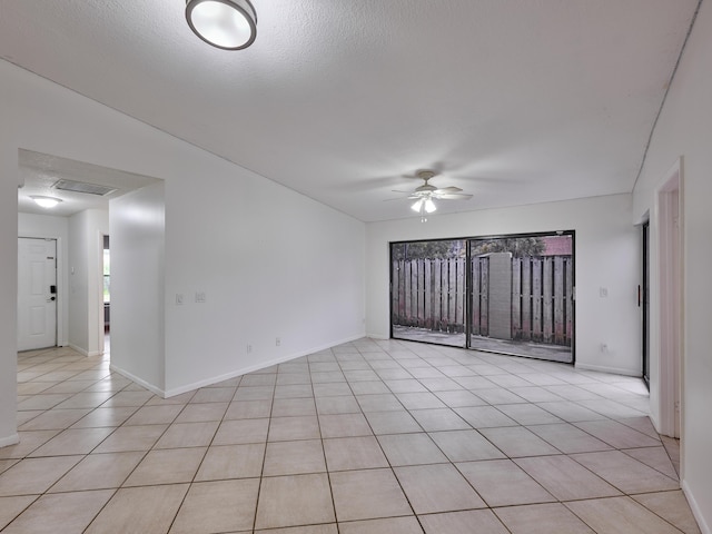 151 Meadows Dr, Boynton Beach, FL 33436 - spare room featuring a ceiling fan, light tile patterned floors, baseboards, and a textured ceiling