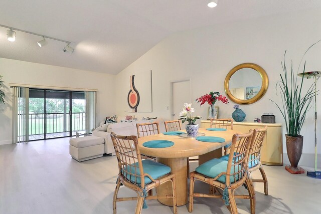 5218 Fountains Dr S Unit 206, Lake Worth, FL 33467 - dining room with vaulted ceiling, track lighting, and baseboards