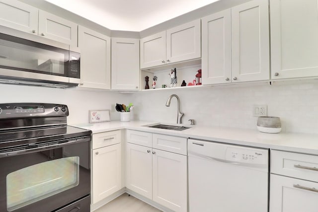 5218 Fountains Dr S Unit 206, Lake Worth, FL 33467 - kitchen with dishwasher, stainless steel microwave, black range with electric cooktop, a sink, and light countertops