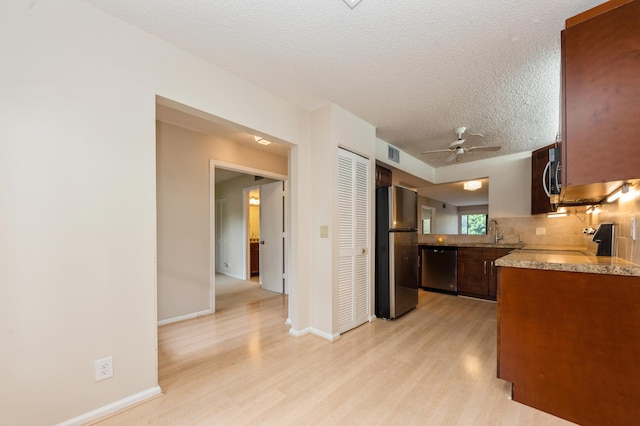 10173 Mangrove Dr Unit 204, Boynton Beach, FL 33437 - kitchen featuring appliances with stainless steel finishes, backsplash, light wood finished floors, ceiling fan, and a textured ceiling