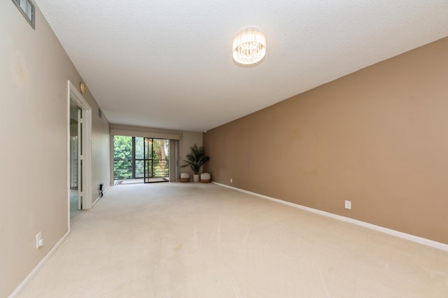 10173 Mangrove Dr Unit 204, Boynton Beach, FL 33437 - unfurnished room featuring light carpet, a chandelier, and baseboards