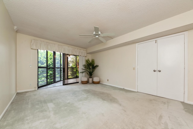 10173 Mangrove Dr Unit 204, Boynton Beach, FL 33437 - spare room with light carpet, a ceiling fan, a textured ceiling, and baseboards