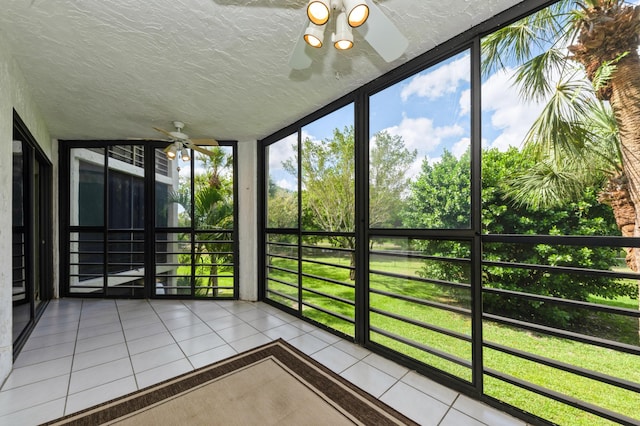 unfurnished sunroom featuring a ceiling fan