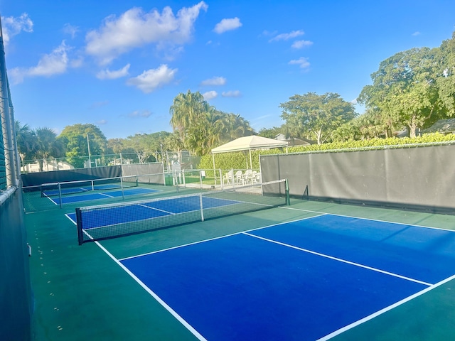 view of tennis court featuring fence
