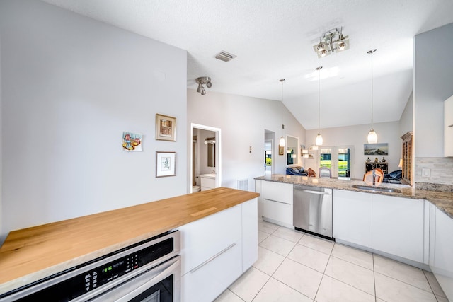 8735 Boca Glades Blvd W Unit D, Boca Raton, FL 33434 - kitchen with appliances with stainless steel finishes, vaulted ceiling, white cabinets, a sink, and light tile patterned floors