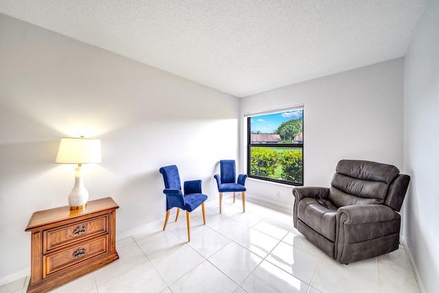 8735 Boca Glades Blvd W Unit D, Boca Raton, FL 33434 - sitting room featuring a textured ceiling and baseboards