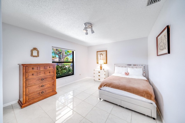 8735 Boca Glades Blvd W Unit D, Boca Raton, FL 33434 - bedroom featuring a textured ceiling, baseboards, and light tile patterned floors