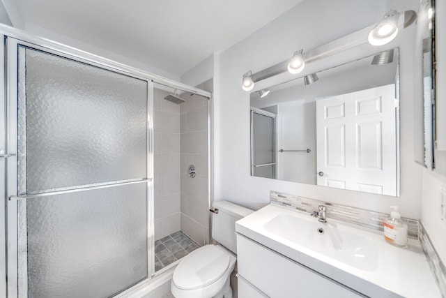8735 Boca Glades Blvd W Unit D, Boca Raton, FL 33434 - bathroom featuring vanity, toilet, a shower stall, and decorative backsplash