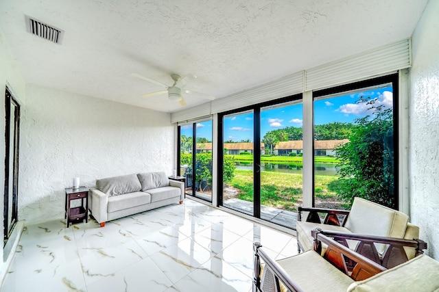 8735 Boca Glades Blvd W Unit D, Boca Raton, FL 33434 - sunroom / solarium featuring a textured wall, marble finish flooring, a textured ceiling, and a water view