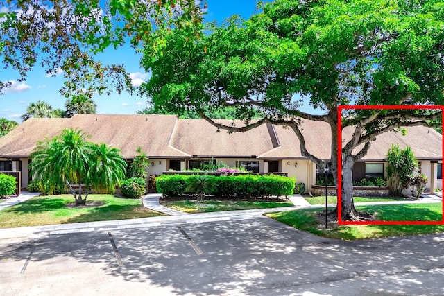 8735 Boca Glades Blvd W Unit D, Boca Raton, FL 33434 - view of property with a front lawn and uncovered parking