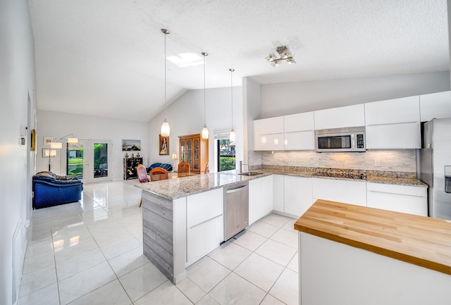 8735 Boca Glades Blvd W Unit D, Boca Raton, FL 33434 - kitchen with stainless steel appliances, backsplash, open floor plan, light tile patterned floors, and high vaulted ceiling