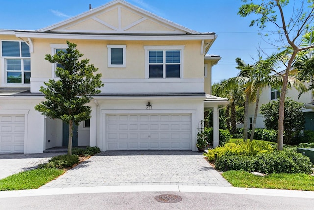 622 Parsons Way, Deerfield Beach, FL 33442 - view of front of house featuring an attached garage, stucco siding, and decorative driveway