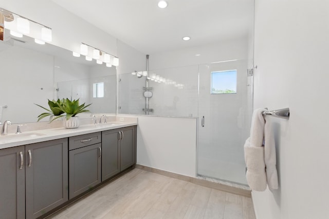 622 Parsons Way, Deerfield Beach, FL 33442 - bathroom featuring a stall shower, wood finished floors, double vanity, and recessed lighting
