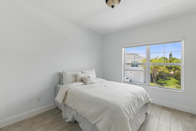 622 Parsons Way, Deerfield Beach, FL 33442 - bedroom featuring baseboards and light wood finished floors