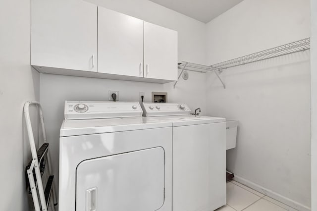 5952 Regal Glen Dr Unit 204, Boynton Beach, FL 33437 - laundry area featuring separate washer and dryer, cabinet space, baseboards, and light tile patterned floors