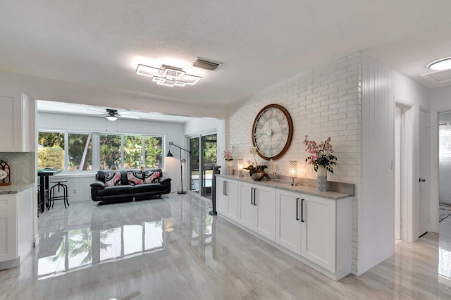 hall featuring a textured ceiling