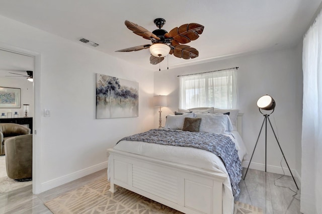 bedroom with baseboards and ceiling fan