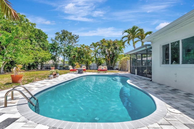 view of swimming pool with a patio, a fenced backyard, and a lanai