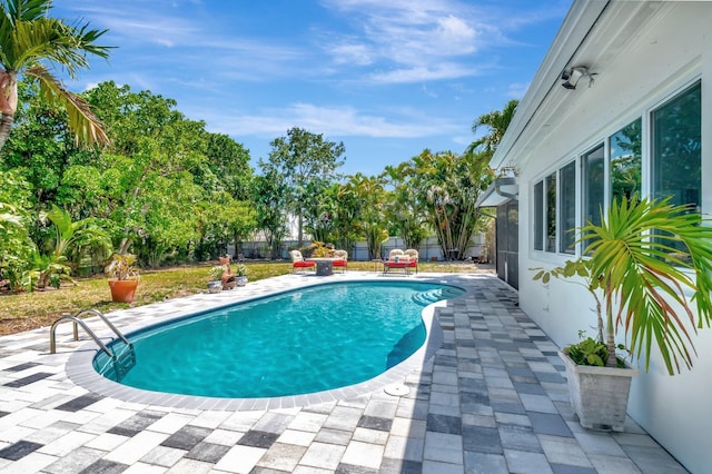 view of swimming pool featuring a patio and a fenced backyard