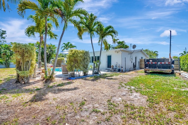 view of yard with an outdoor pool, a patio, and fence