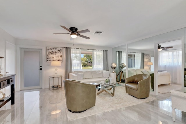 living area featuring ceiling fan