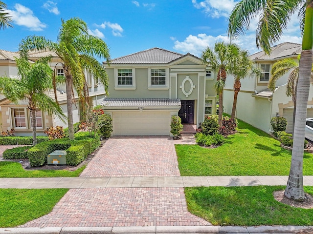 9226 Dupont Pl, Wellington, FL 33414 - view of front facade with decorative driveway, a tile roof, stucco siding, an attached garage, and a front yard