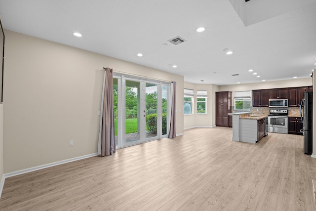 9226 Dupont Pl, Wellington, FL 33414 - kitchen featuring stainless steel appliances, open floor plan, light wood-type flooring, baseboards, and recessed lighting