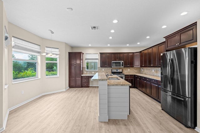 9226 Dupont Pl, Wellington, FL 33414 - kitchen with stainless steel appliances, decorative backsplash, light wood-style flooring, and recessed lighting