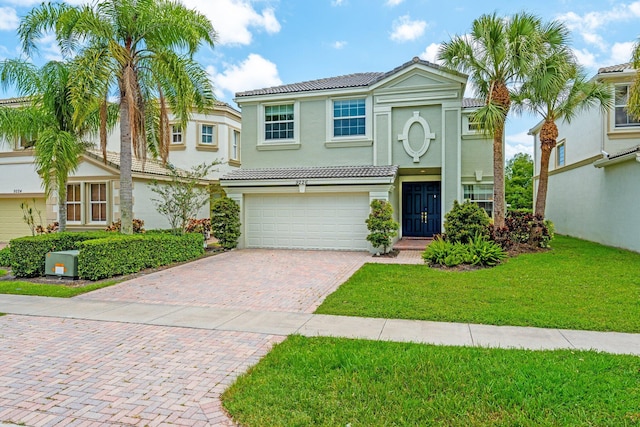 9226 Dupont Pl, Wellington, FL 33414 - view of front facade featuring a tiled roof, stucco siding, an attached garage, decorative driveway, and a front yard