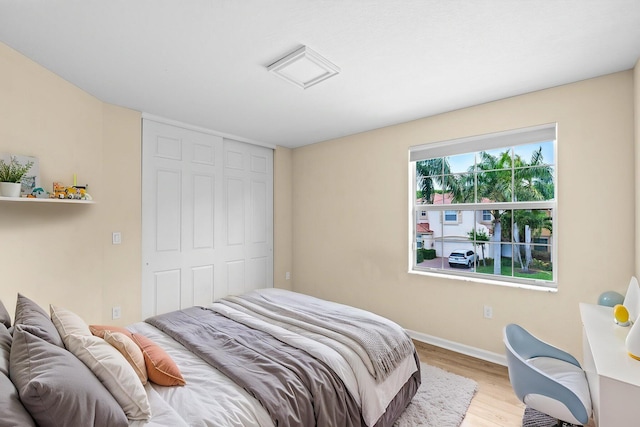 9226 Dupont Pl, Wellington, FL 33414 - bedroom featuring baseboards, wood finished floors, and a closet