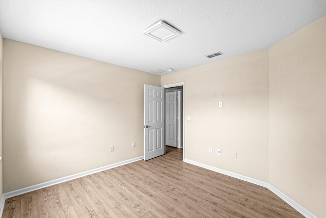 9226 Dupont Pl, Wellington, FL 33414 - unfurnished room with light wood-type flooring, baseboards, and a textured ceiling