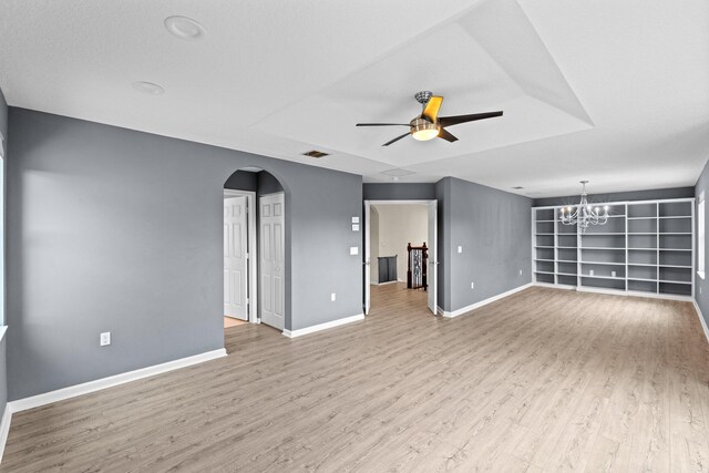 9226 Dupont Pl, Wellington, FL 33414 - unfurnished living room featuring arched walkways, a ceiling fan, wood finished floors, and baseboards