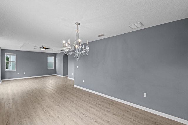 9226 Dupont Pl, Wellington, FL 33414 - unfurnished room with a chandelier, wood finished floors, ceiling fan, baseboards, and arched walkways