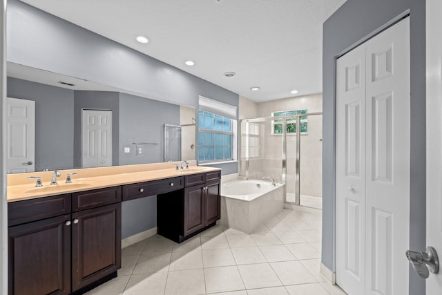 9226 Dupont Pl, Wellington, FL 33414 - full bathroom featuring a closet, a bath, a stall shower, double vanity, and tile patterned flooring