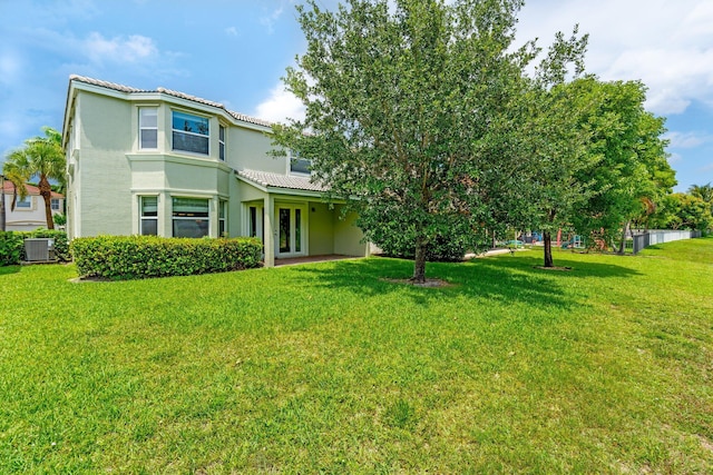 9226 Dupont Pl, Wellington, FL 33414 - view of front of home featuring stucco siding, a tile roof, central AC, and a front yard