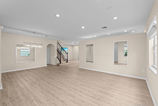 9226 Dupont Pl, Wellington, FL 33414 - unfurnished living room with stairs, light wood finished floors, baseboards, recessed lighting, and a chandelier
