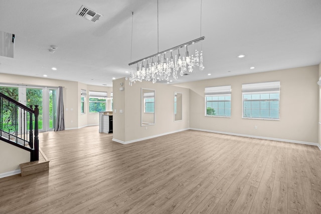 9226 Dupont Pl, Wellington, FL 33414 - unfurnished living room featuring light wood finished floors, baseboards, recessed lighting, and stairs