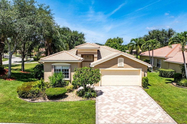 10887 Summerville Way, Boynton Beach, FL 33437 - mediterranean / spanish-style house with stucco siding, a front yard, decorative driveway, a garage, and a tiled roof