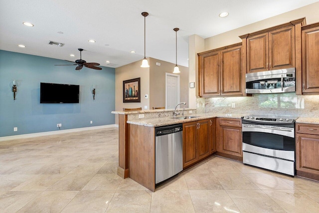 10887 Summerville Way, Boynton Beach, FL 33437 - kitchen featuring stainless steel appliances, brown cabinets, a sink, ceiling fan, and tasteful backsplash