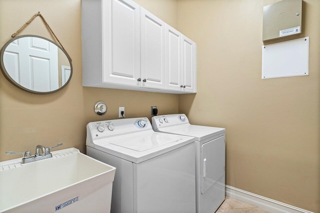 10887 Summerville Way, Boynton Beach, FL 33437 - washroom featuring washer and clothes dryer, cabinet space, baseboards, and light tile patterned flooring