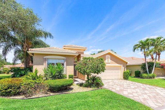 10887 Summerville Way, Boynton Beach, FL 33437 - mediterranean / spanish-style house featuring a garage, stucco siding, decorative driveway, a tile roof, and a front yard
