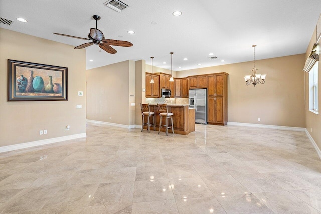 10887 Summerville Way, Boynton Beach, FL 33437 - kitchen featuring appliances with stainless steel finishes, brown cabinets, a chandelier, a breakfast bar area, and recessed lighting