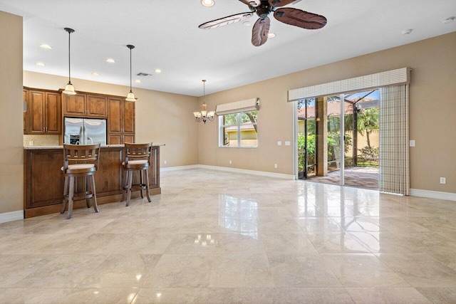 10887 Summerville Way, Boynton Beach, FL 33437 - kitchen featuring stainless steel fridge with ice dispenser, baseboards, ceiling fan, a chandelier, and brown cabinets