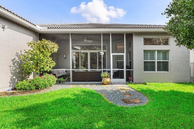 9037 Golden Mountain Cir, Boynton Beach, FL 33473 - rear view of property featuring a sunroom, stucco siding, and a lawn