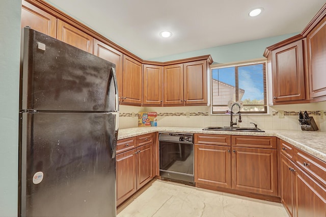 kitchen featuring black appliances, a sink, light countertops, tasteful backsplash, and recessed lighting