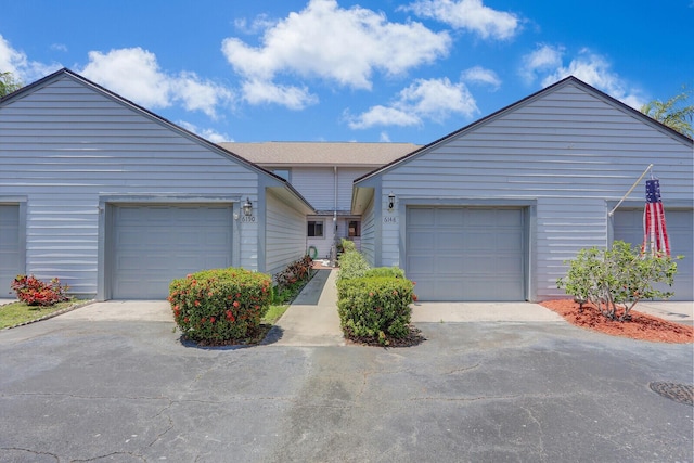 view of front of property featuring concrete driveway and a garage