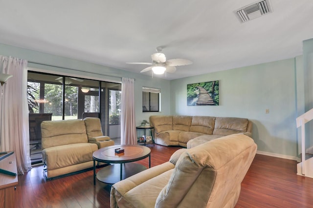 living room featuring wood finished floors, ceiling fan, and baseboards