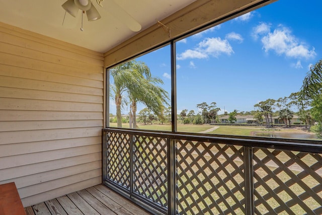 unfurnished sunroom featuring a ceiling fan
